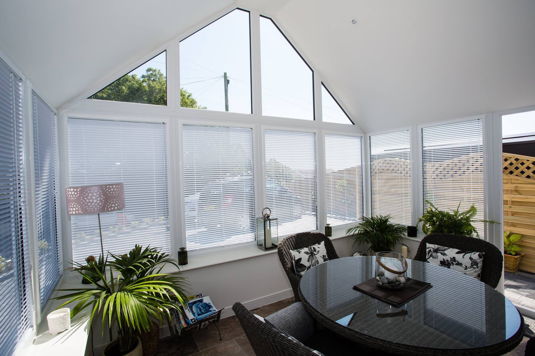 Kitchen and dining space in a conservatory with a warm roof system providing natural light