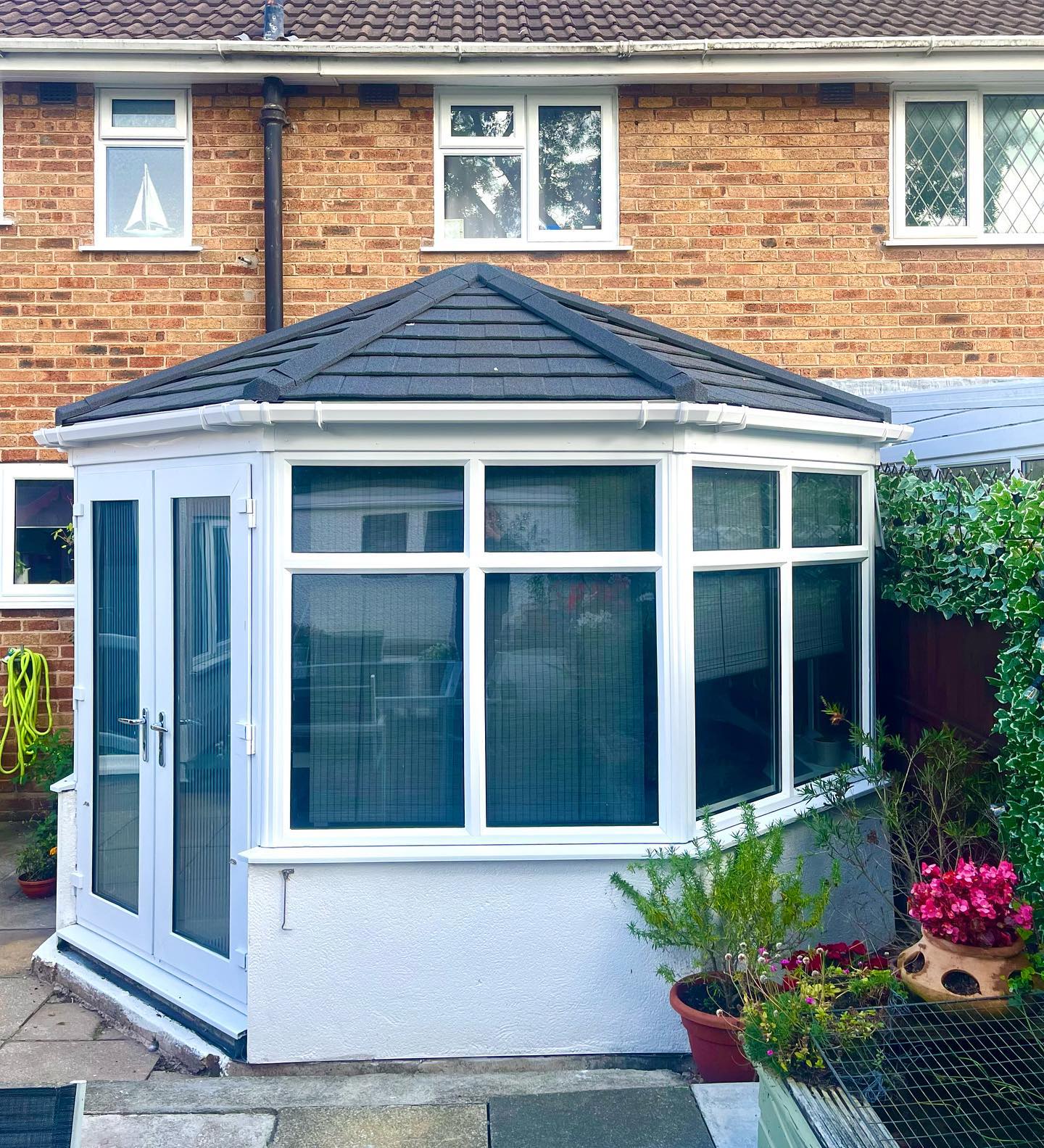 Modern house with a solid conservatory roof blending into the property design